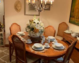 Beautiful dining room table. Has 6 chairs and 2 leaves. Artwork