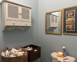 white wall cabinet mirrors large basket of socks