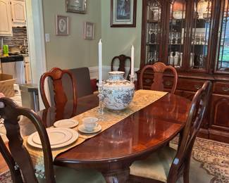 dining room table with matching chairs display case with drawers and storage art area rug
