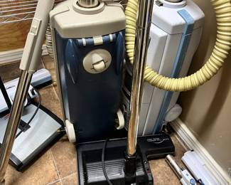 Two Electrolux vacuum cleaners with attachments