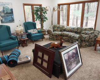 wing back arm chairs, curved sofa, storage ottomans, leather wrapped elk, table lamps