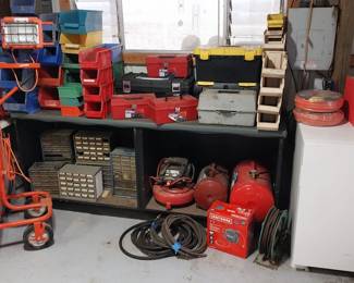 storage, air compressor and tanks, small freezer, air hose, work light, tool boxes