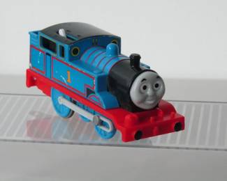 This is a battery-operated Thomas the Tank Engine that can pull the other cars. See other lots for other train cars. TOMY Plarail from 1990s.