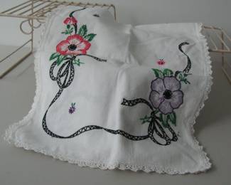 This table runner measures about 34 inches and features some very fine embroidery. There are no stains or tears. The thread colors and fabric are bright.