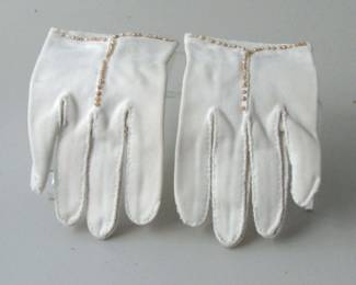 These vintage ladies gloves are white decorated with what appear to be beige rice pearls. They are a perfect size small. Still very soft material.