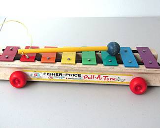 This 1964 Fisher Price Pull-a-Tune is perfectly playable and includes the original mallet. This classic toy provides hours of creative play with a pleasing sound. During it's long production, the xylophone was slightly changed with different lithographs on the sides, wooden wheels verses plastic wheels, wooden mallet verses plastic mallet, etc., but the over-all look, action, and appeal remain the same through all of the years.