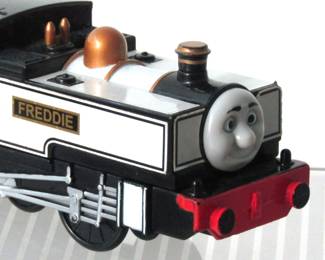 Freddie, also known as "Fearless Freddie" is a train engine in the Thomas and Friends series. He first appeared in 2006. This is a battery-operated engine that can pull the other train cars that are available in other lots in this auction.