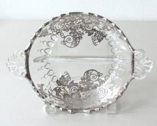 This silver overlay glass dish includes a scalloped edge and two sections divided by glass. It is likely made by Silver City.