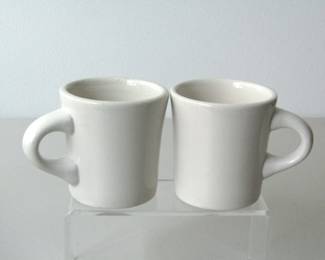 These mugs were made by Buffalo China after 2004. They are in good condition with just a few scratches around the inside of the rims at the top.