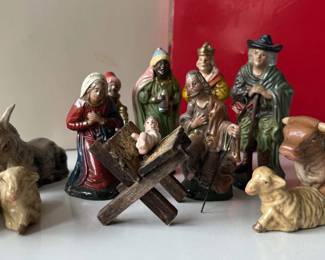 This 13-piece creche, also known as a nativity scene, includes all the key characters: Jesus, Mary, Joseph, the three kings/wise men, and a shepherd along with his three sheep. There's even a donkey, a cow, and a manger bed. All pieces marked "Made in Western Germany" and appear to be made from paper mache.