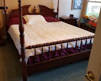 California king poster bed with pineapple design.