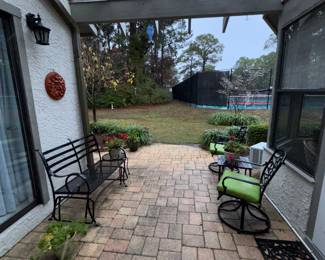 Awesome set of wrought iron patio furniture. Glider, tables, swivel chairs, and chaise lounge.