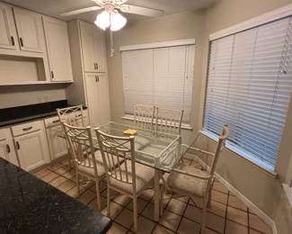 Glass tabletop and metal chairs seats 6