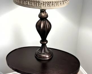 Dark wood oval side table, with lamp.                                     25" W x 15" D x 22" H.