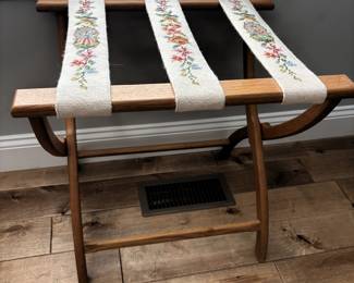 Beautifully needlepointed oak luggage holder.