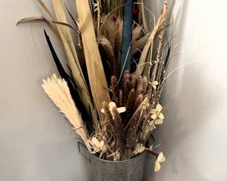 Dried flower arrangement in decorator bucket.