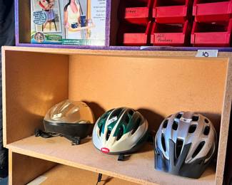 bike helmets, small red storage containers, wood shelves