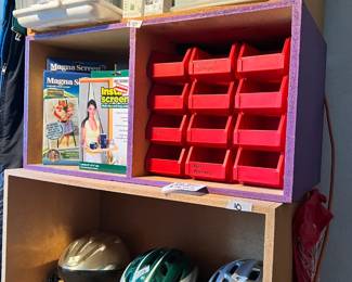 bike helmets, small red storage containers, wood shelves