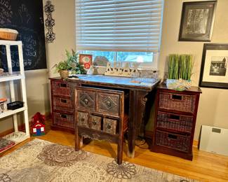 Wooden desk with pull out drawer and chair with three long deep storage drawers, wicker storage baskets, various crafts