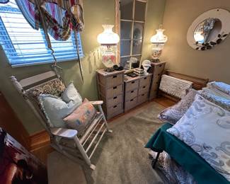 pillows, comforters, rocking chair, mirror, wicker storage units