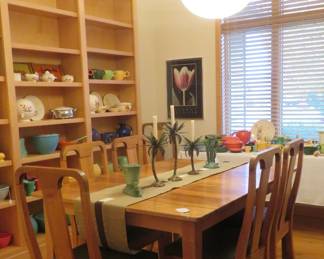 Our dining room featuring an Amana maple table with 5 leaves and six leather seat chairs. Shares room with massive displays of older Fiesta Ware, Homer Laughlin Kitchen Kraft and some Bauer.