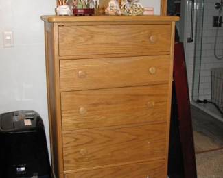 tall dresser with wall mirror behind it and a air conditioner beside it