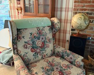 Traditional wingback chair in floral upholstery with wood accents. Comfortable and perfect for reading nooks or living rooms.