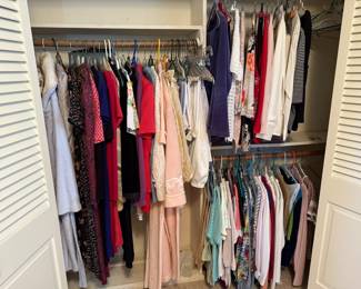 Assorted women’s clothing including blouses, jackets, sweaters, dresses, and nightwear—variety of sizes and styles.