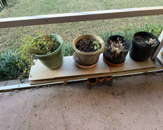 Assorted outdoor planters with pots and plant stands—various sizes and materials.