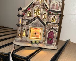 Miniature illuminated church from a Christmas village set—perfect for holiday displays.