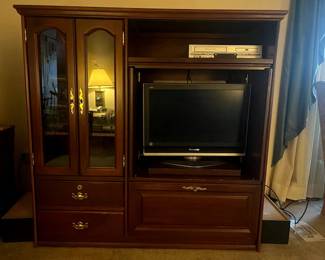 Solid cherry entertainment center and display cabinet. swivel TV and VHS/DVD player.