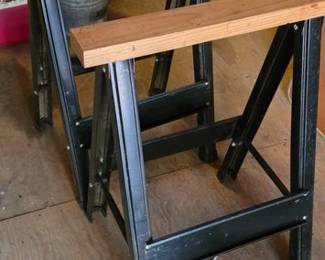 Pair of metal top wood base saw horses. Multiple sets available in auction