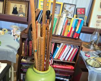 Large floor vase full of vintage collectable yardstick and walking sticks