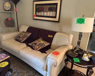Living Room Furniture set. white leather like Sofa, Coffee Table and Matching Side Table, Custom Lamp, Beautiful Artwork and Decor Items.