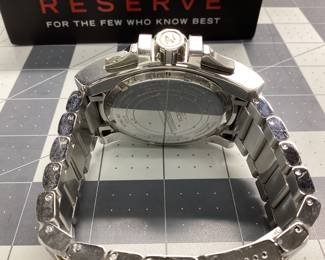 INVICTA 15314 RESERVE THIS RESERVE SERIES WATCH FEATURES CARBON FIBER DIAL CHRONOGRAPH WITH GOLD ACCENTS OVERSIZED HEAVY STRUCTURE