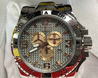 INVICTA 15314 RESERVE THIS RESERVE SERIES WATCH FEATURES CARBON FIBER DIAL CHRONOGRAPH WITH GOLD ACCENTS OVERSIZED HEAVY STRUCTURE