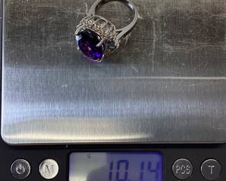 14k Amethyst Ladies Ring This Beautiful 14 Karat 10.14 Gram White Gold Ring Features 10 Carat Oval Amethyst Surrounded By 1 Carat Round Diamonds And 1/2 Carat Blue Diamond Baguettes (stone Weights Are Approximate) Size 6.5
