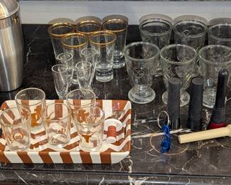 Assorted barware - shot glasses, wine glasses, goblets, corkscrews, bottle openers, etc
