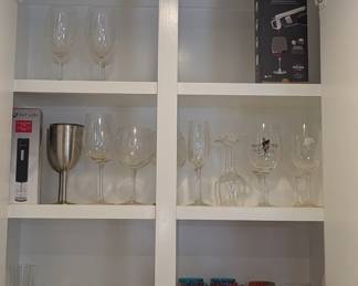 Assorted wine accessories - stem and stemless glasses, decanter devices, corkscrews, decorative wine stoppers, etc