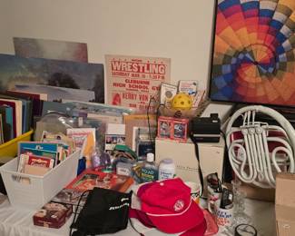 Notebooks, puzzles, hats, recipe booklets, a tabletop fountain and some glassware.