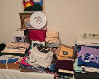 Basement bedroom to the left. Some vintage clothing, unframed needlepoint, and more.