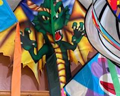 Vibrant dragon-themed kite with bold lightning-storm artwork and long colorful tails—great for high-flying outdoor fun and fantasy-themed décor.