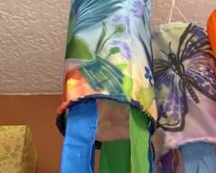 Bright butterfly and floral windsocks with colorful ribbon streamers, perfect for porch, patio, or garden décor.