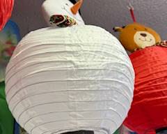 

White round paper lantern with a snowman topper, perfect for holiday décor, winter displays, kids’ rooms, or festive hanging decorations.