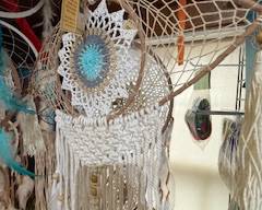 Handwoven boho dreamcatcher with detailed crochet center, natural fibers, wooden bead accents, and long fringe tassels. Beautiful hanging décor for bedrooms, patios, or artistic displays.