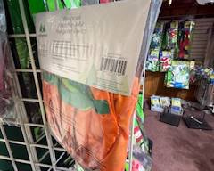 Packaged garden windsock with bright orange and green design, ready to hang for porch, patio, or yard décor. Great for adding color and movement to outdoor spaces.