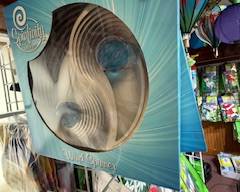 Metal spiral wind spinner in original packaging, featuring an optical swirl design that rotates beautifully outdoors. Perfect for garden décor, patios, or hanging yard accents.