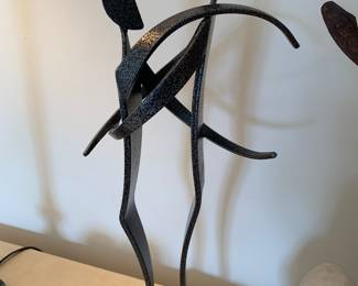 Large enameled metal sculpture of a couple in embrace