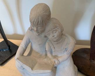 cast sculpture of two girls reading