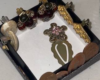 Earrings, pressed collector pennies, and a book mark